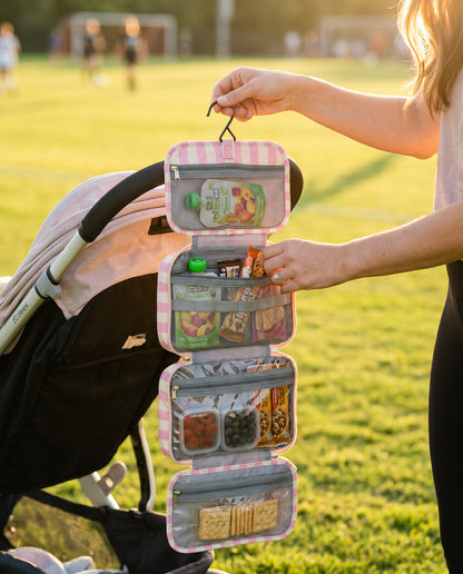 Mama Snack Bag hanging from stroller at sports field